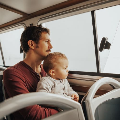 A resident father and his son riding on a bus near Madigan in Joint Base Lewis McChord, Washington