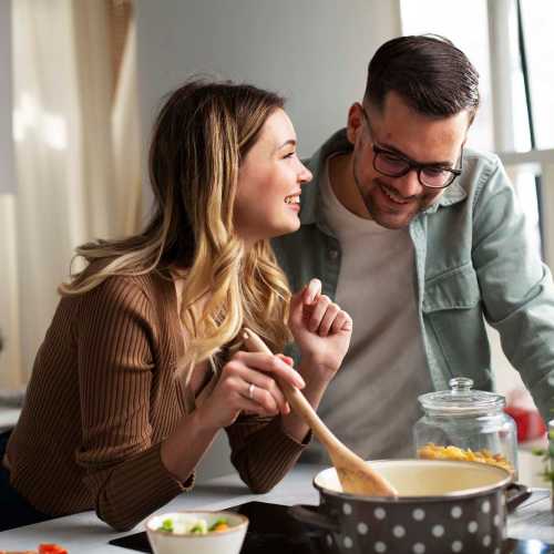 Residents cooking in an apartment kitchen at Flatiron West Trade in Charlotte, North Carolina