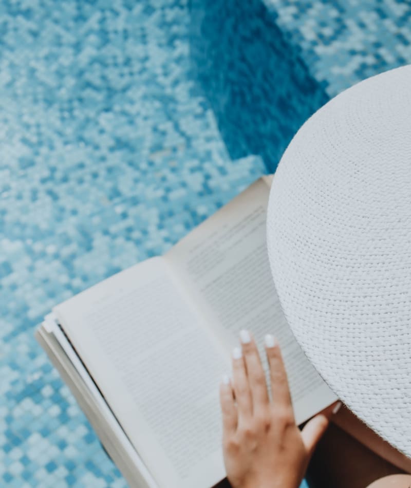 Resident reading by the pool at Mercury NoDa in Charlotte, North Carolina