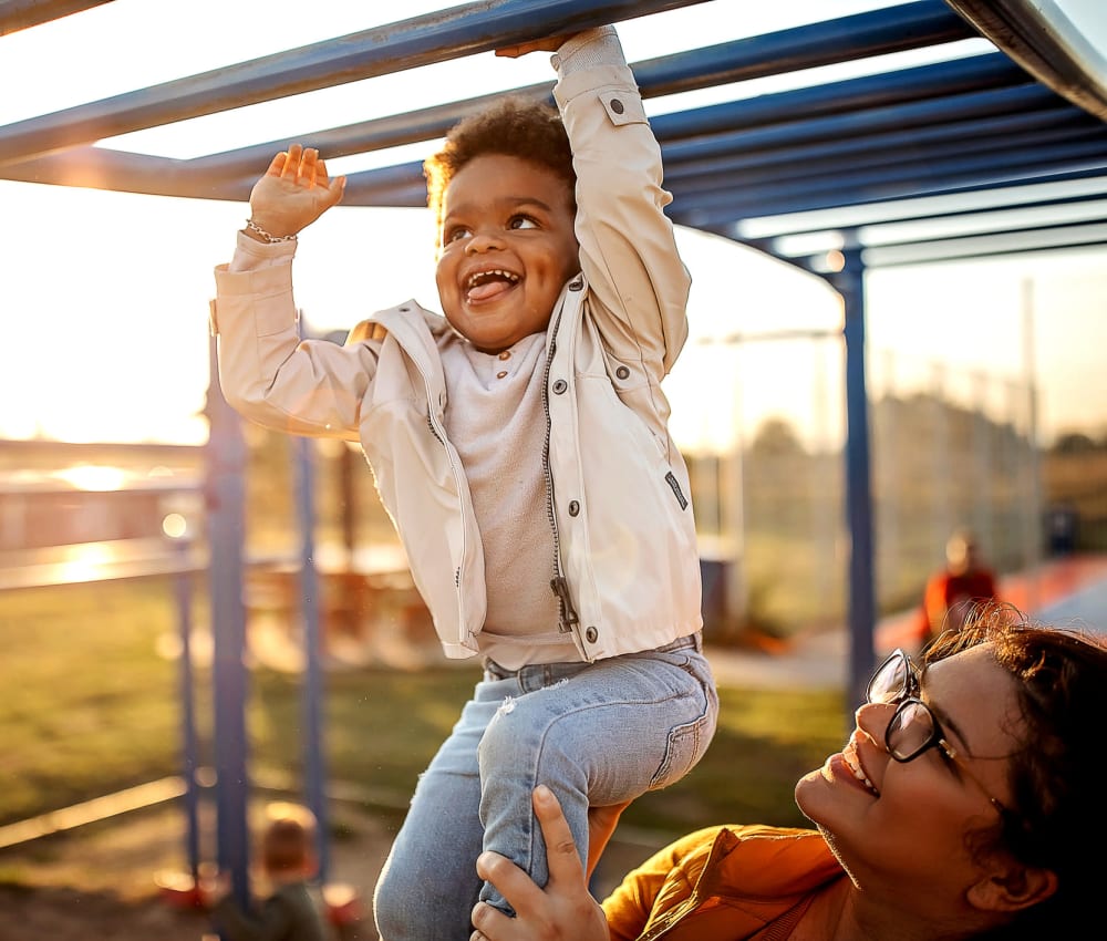 Kid doing the monkey bars at school near Montecito Apartments in Santa Clara, California