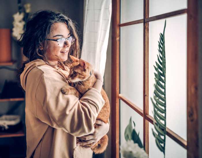 Resident holding her cat in their home at The Trails at Summer Creek in Fort Worth, Texas