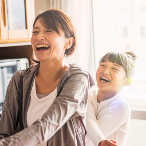 A laughing mother and daughter at Lofgren Terrace in Chula Vista, California