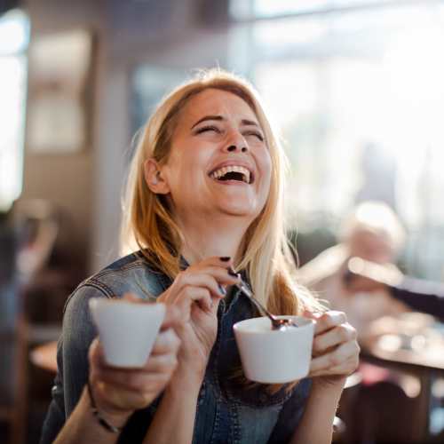 Woman having coffee at a café near The Kensington in Charlotte, North Carolina