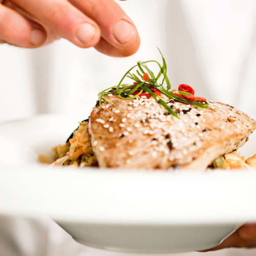 Chef putting the finishing touches on a dish cooked at a restaurant near Landmark Apartments Phase II in Little Rock, Arkansas
