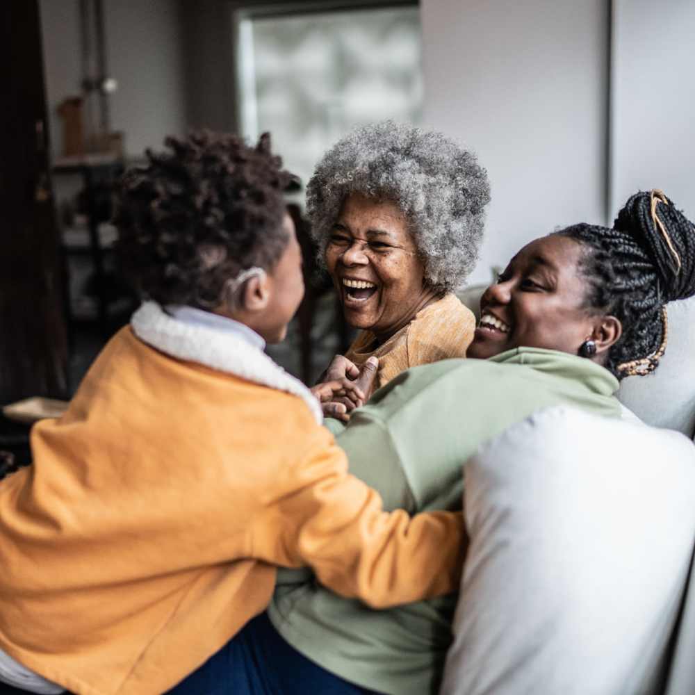 Happy family in their living room at City's Edge in Pittsburgh, Pennsylvania 