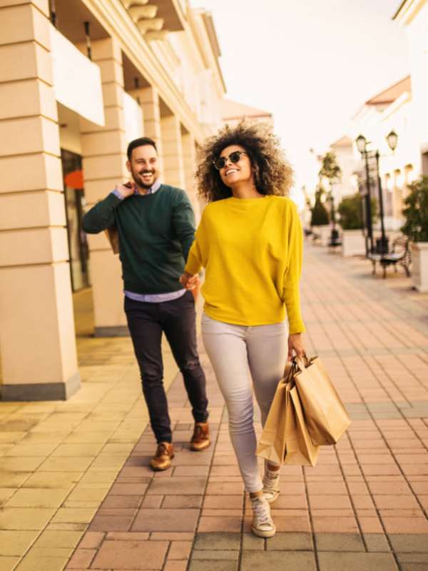Residents with shopping bags near Fountains at Mooresville Town Square in Mooresville, North Carolina