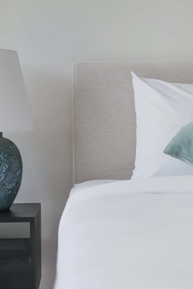 Comfortably furnished primary bedroom in a model apartment at Pinyon Apartments in Reno, Nevada