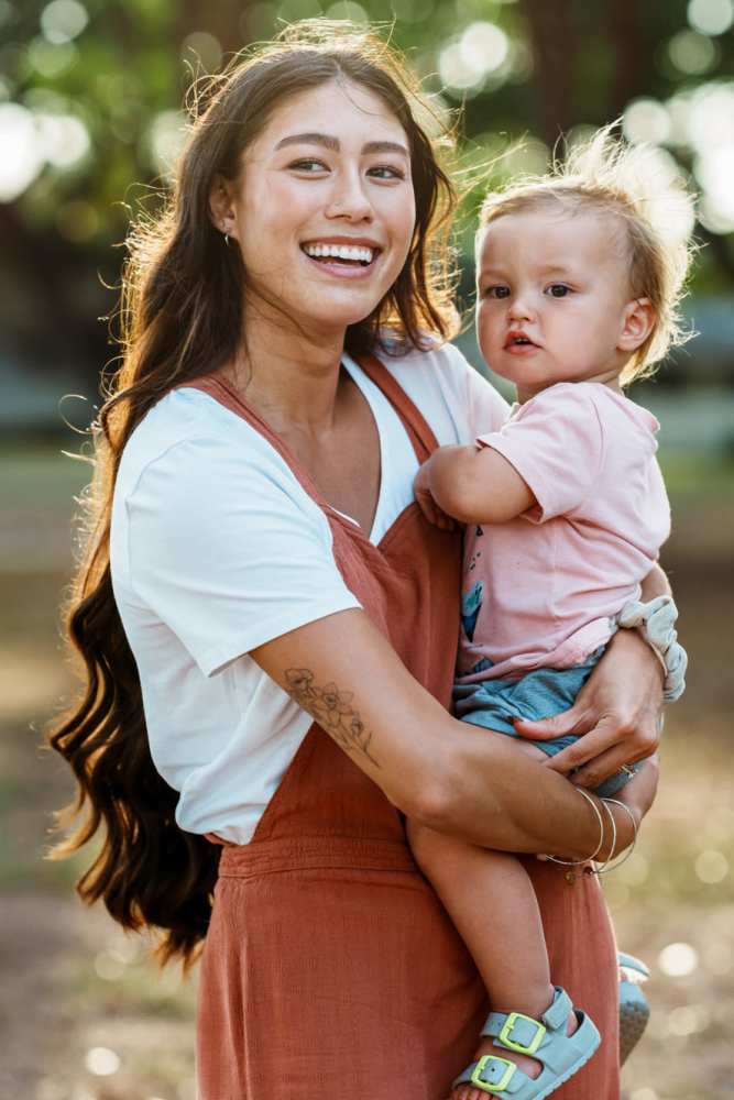 Woman holding a child at Sulzbacher Village in Jacksonville, Florida