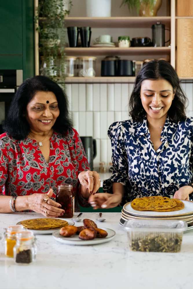 Resident dicing fresh vegetables in her modern kitchen at Willow Grove in Modesto, California
