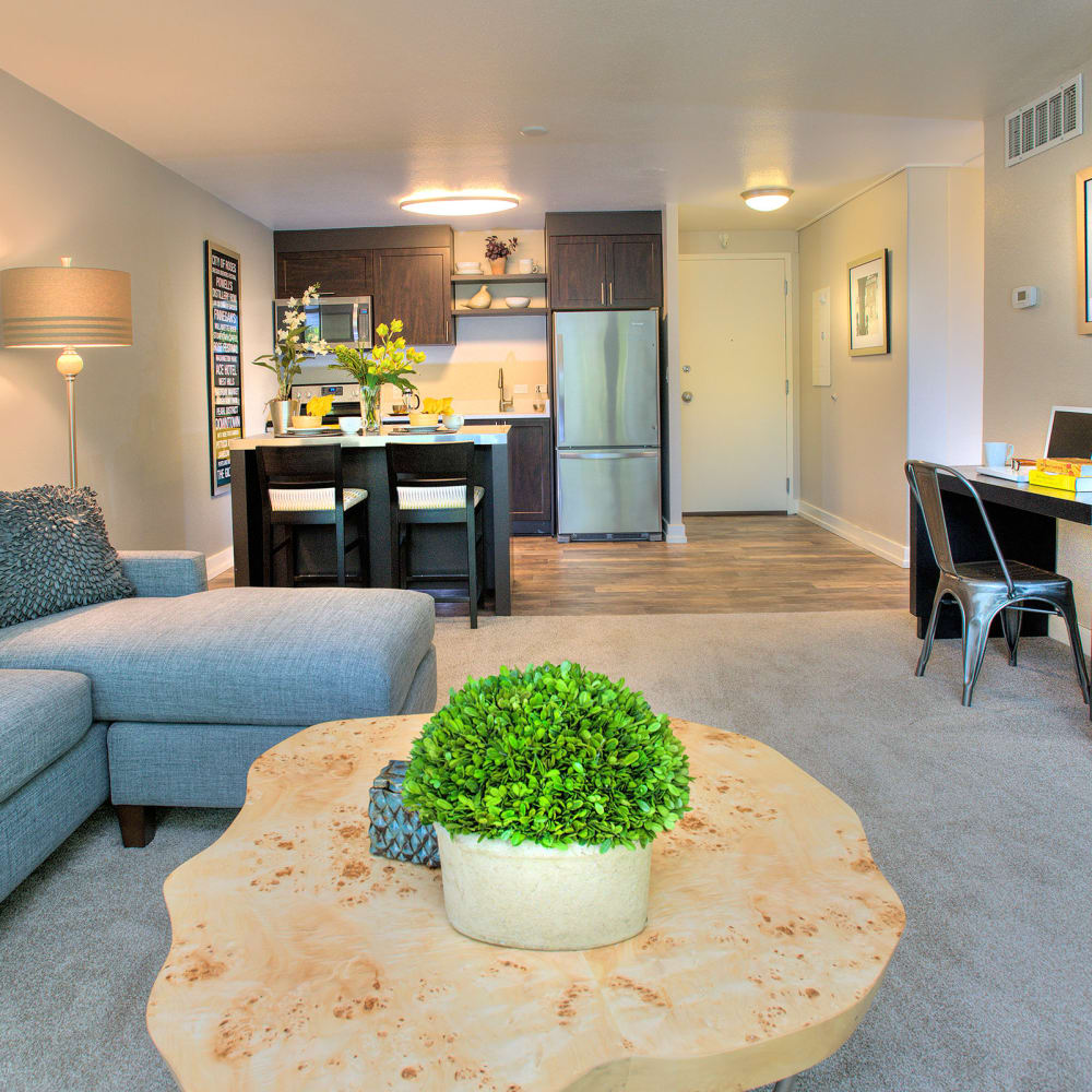 Spacious living room with plush carpeting at Harrison Tower in Portland, Oregon