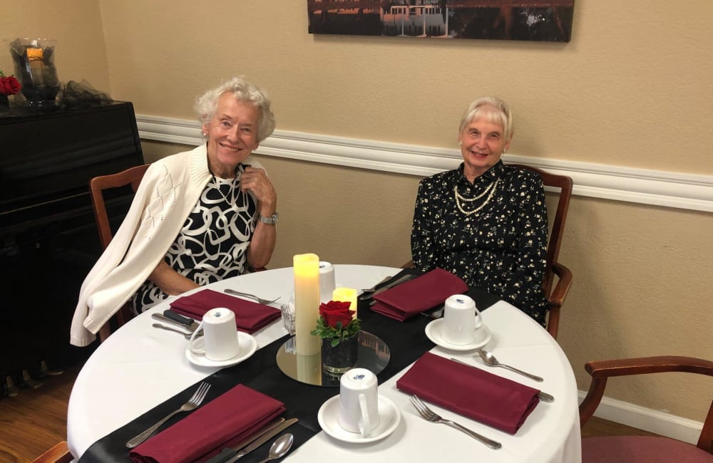 Two residents at a dinner table at Lodi Commons Senior Living in Lodi, California