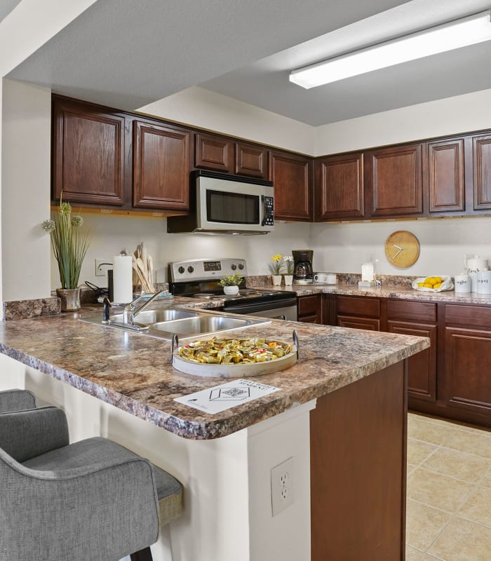 The Kitchen with granite countertops at Park at Mission Hills in Broken Arrow, Oklahoma