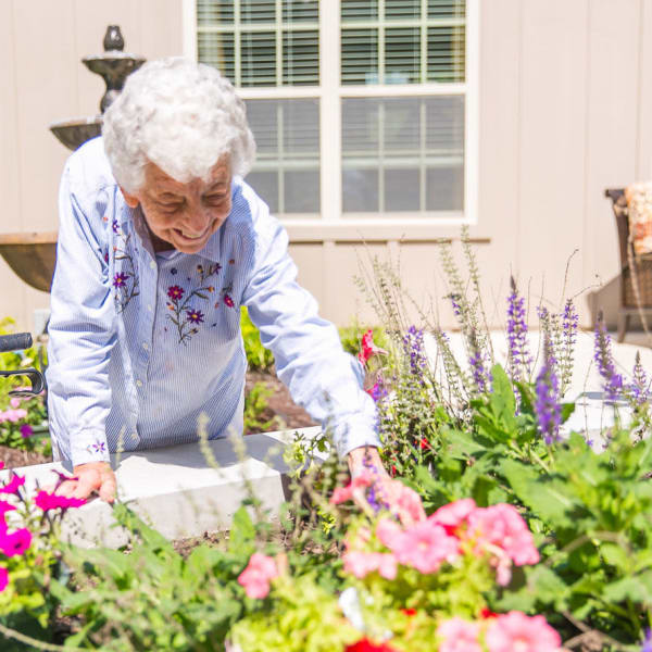 Resident looking at flowers at The Castlewood Senior Living in Nixa, Missouri