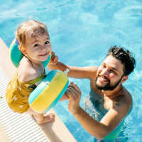 Resident with her daughter on the edge of a pool at Reserve at Regents Center in Lexington, North Carolina