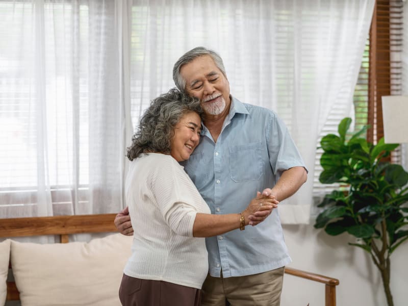 A resident couple dancing at Woodland Palms Memory Care in Tucson, Arizona. 