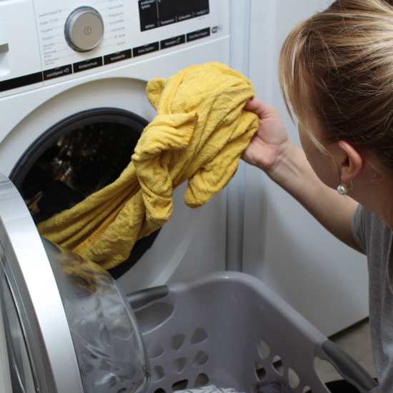 Resident using laundry facility at The Oaks At Northshore in Chattanooga, Tennessee