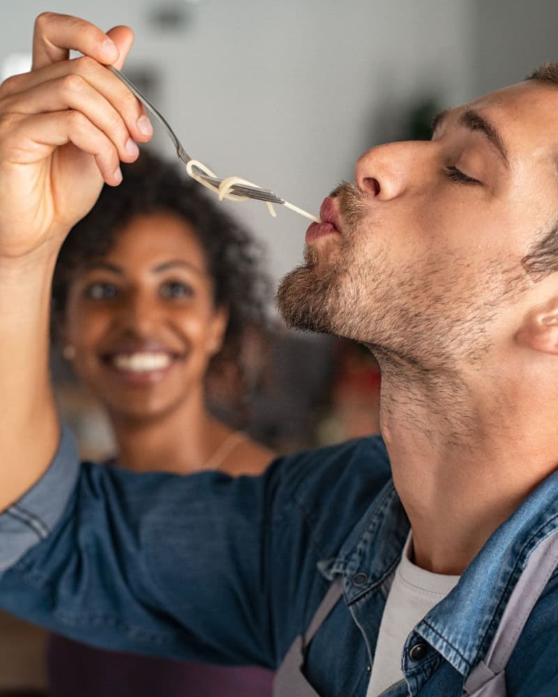 A couple in the kitchen testing food at Creekside Park Apartments in Napa, California