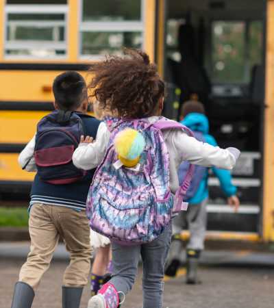 Kids boarding school bus at Ironwood Greens in Gresham, Oregon