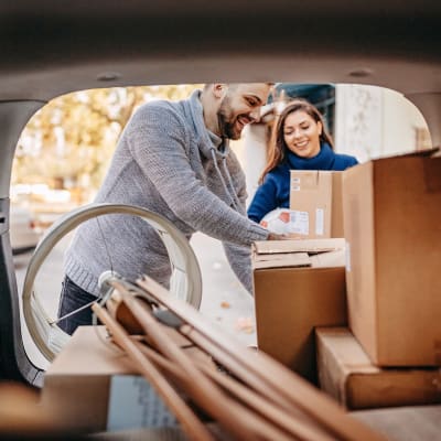 Couple unloading boxes from their car at A-American Self Storage in Ridgecrest, California