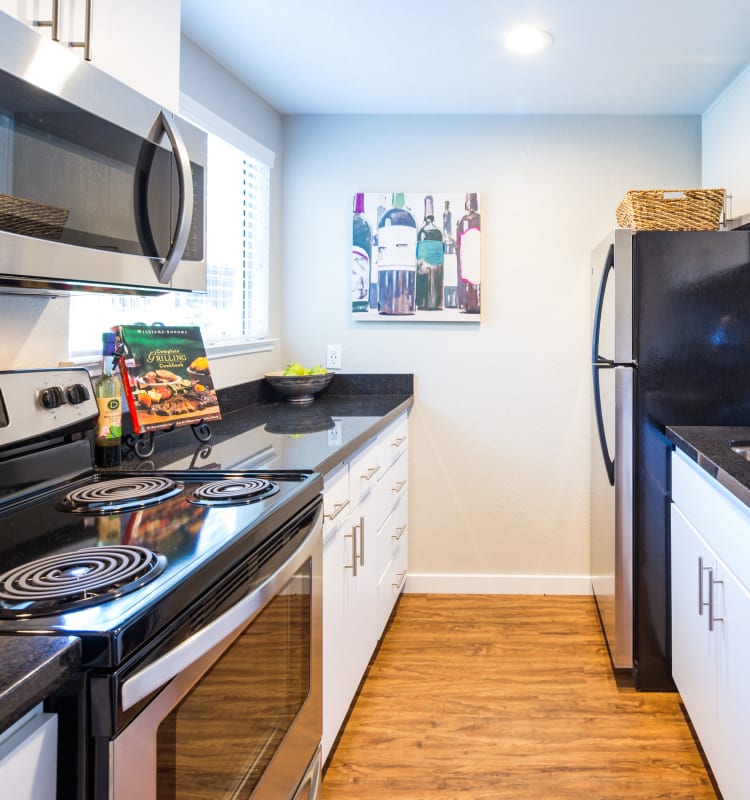 Kitchen with stainless-steel appliances in a model home at Haven Martinez in Martinez, California