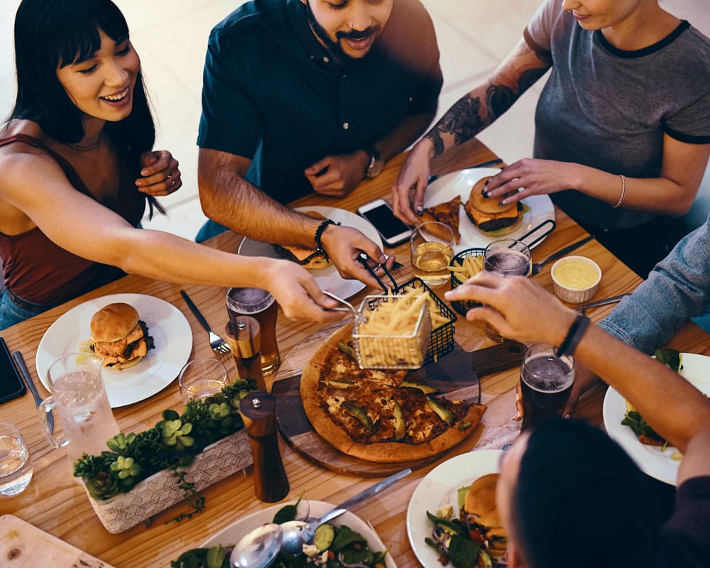 residents enjoying dinner together outside at Colonial Gardens in Fremont, California