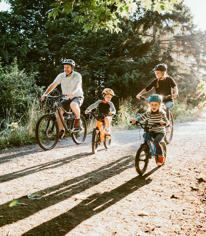 Resident family returning home from a bike ride through the neighborhood at Mission Rock at Novato in Novato, California