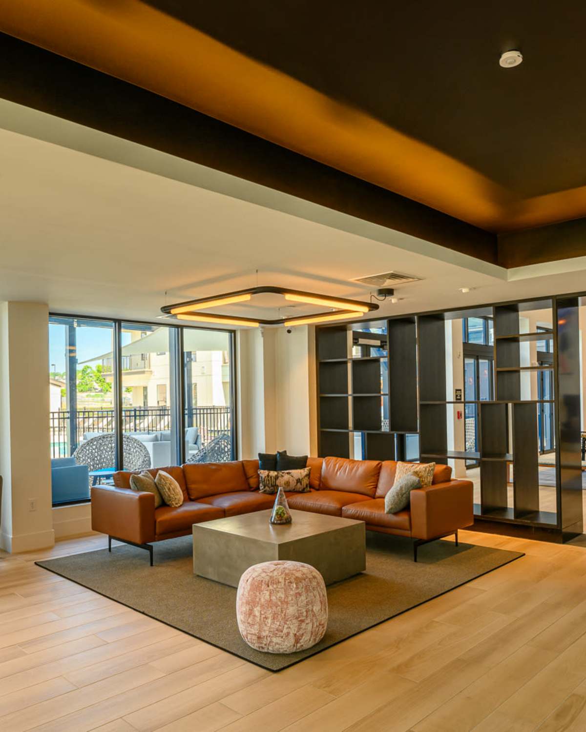 Spacious living room with couch, coffee table, chairs, and hard-wood style flooring at The Concord in Wilmington, Delaware