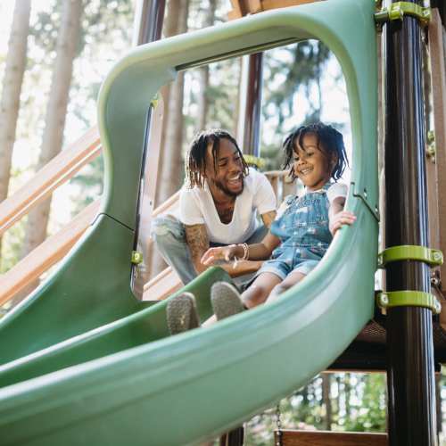 Resident playing with his child in a community playground at Baywoods in Antioch, California