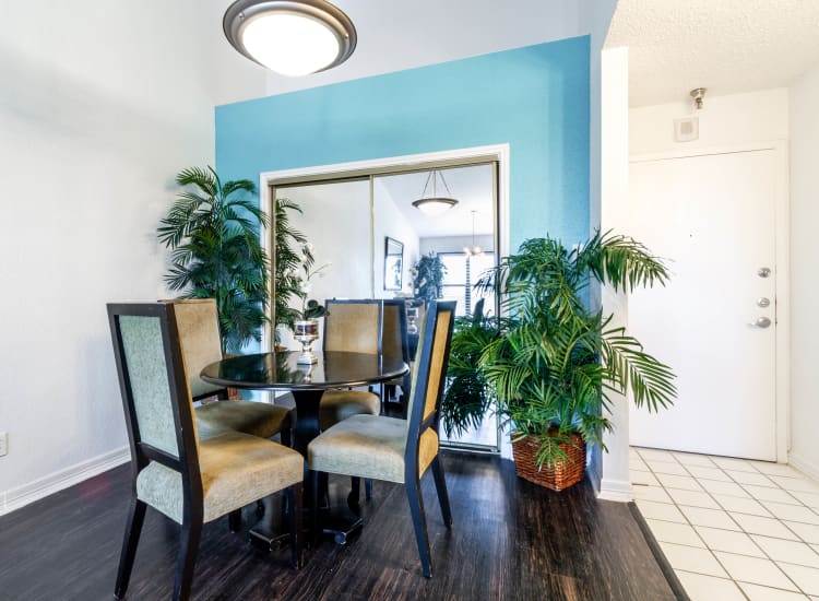 Dining nook with an accent wall near the tiled entry to a model home at Clear Lake Place in Houston, Texas