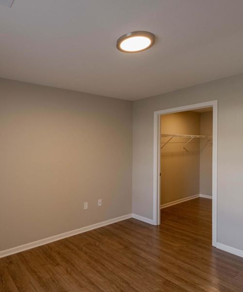 Beautiful bedroom with wood-style flooring at Kershaw Greene III in Athens, Ohio