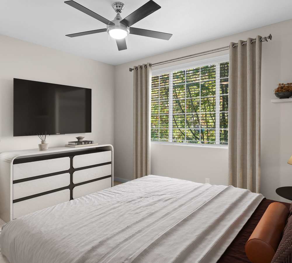 Master bedroom with a large window for natural lighting at Cortland Village Apartment Homes in Hillsboro, Oregon
