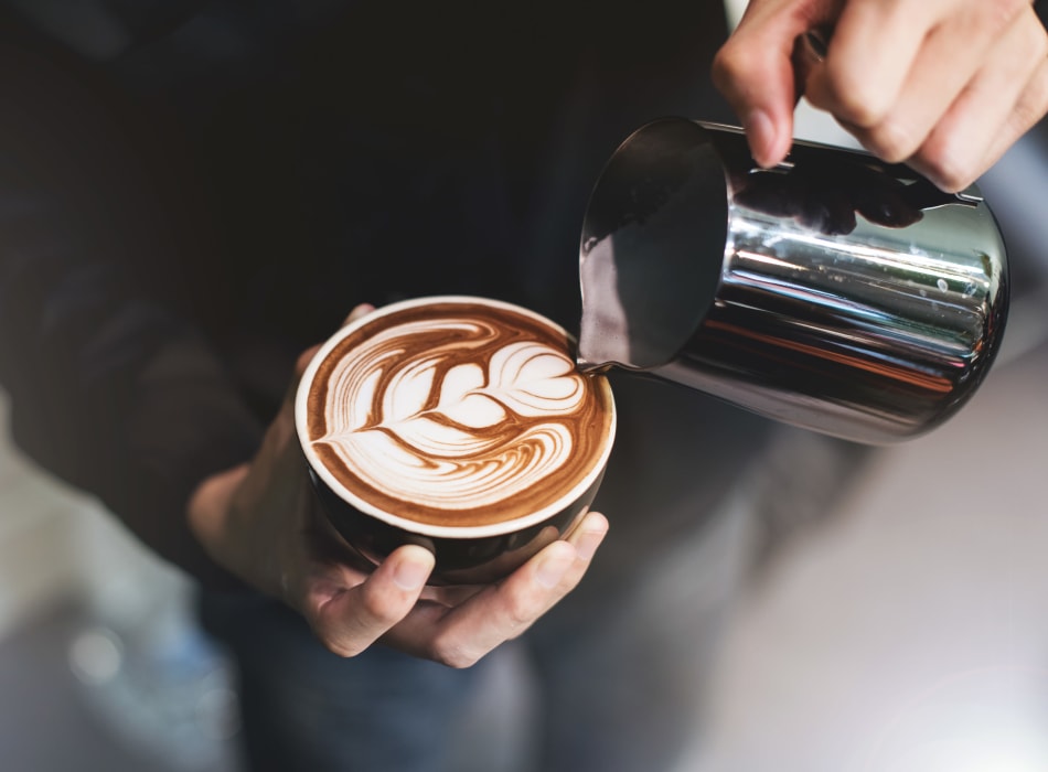 Barista making a latté for a customer near Sofi Parc Grove in Stamford, Connecticut