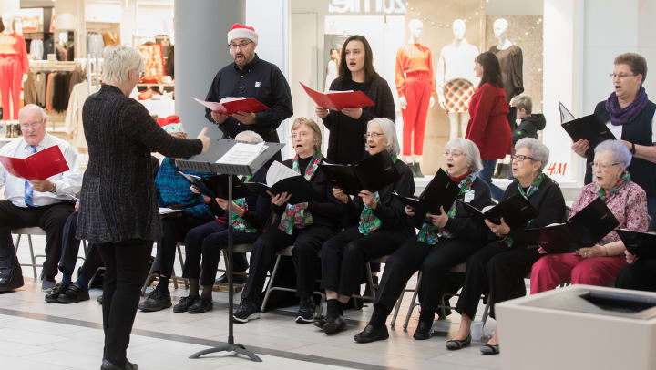 Image of Touchmark residents in their choir singing at Kirkwood Mall in Bismarck, North Dakota.