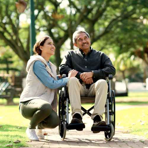 Resident in a wheelchair at a park with another resident near The Villas at Rowland Heights in Rowland Heights, California
