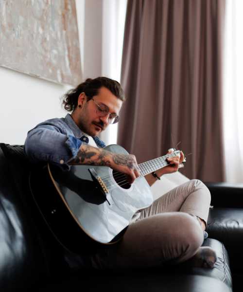 Resident playing guitar at Peachtree Apartments in Chesterfield, Missouri