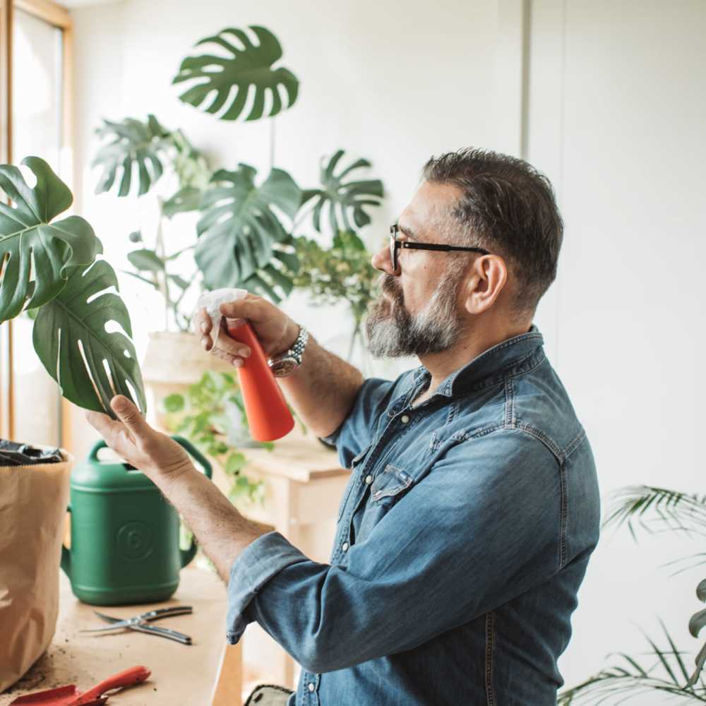 Resident watering plants at Boulder Crescent in Colorado Springs,Colorado