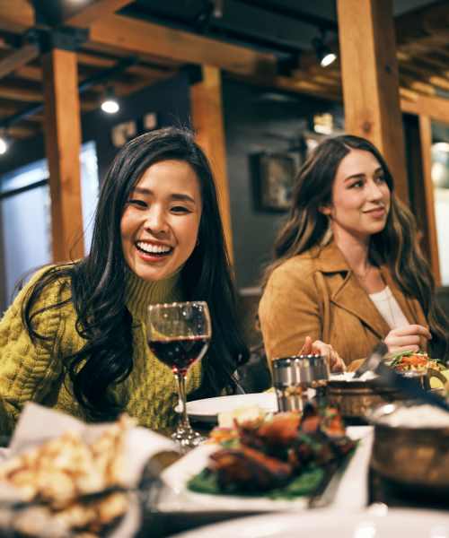 Friends enjoying their meal in the local restaurant near UTE Creek Apartments in Longmont, Colorado