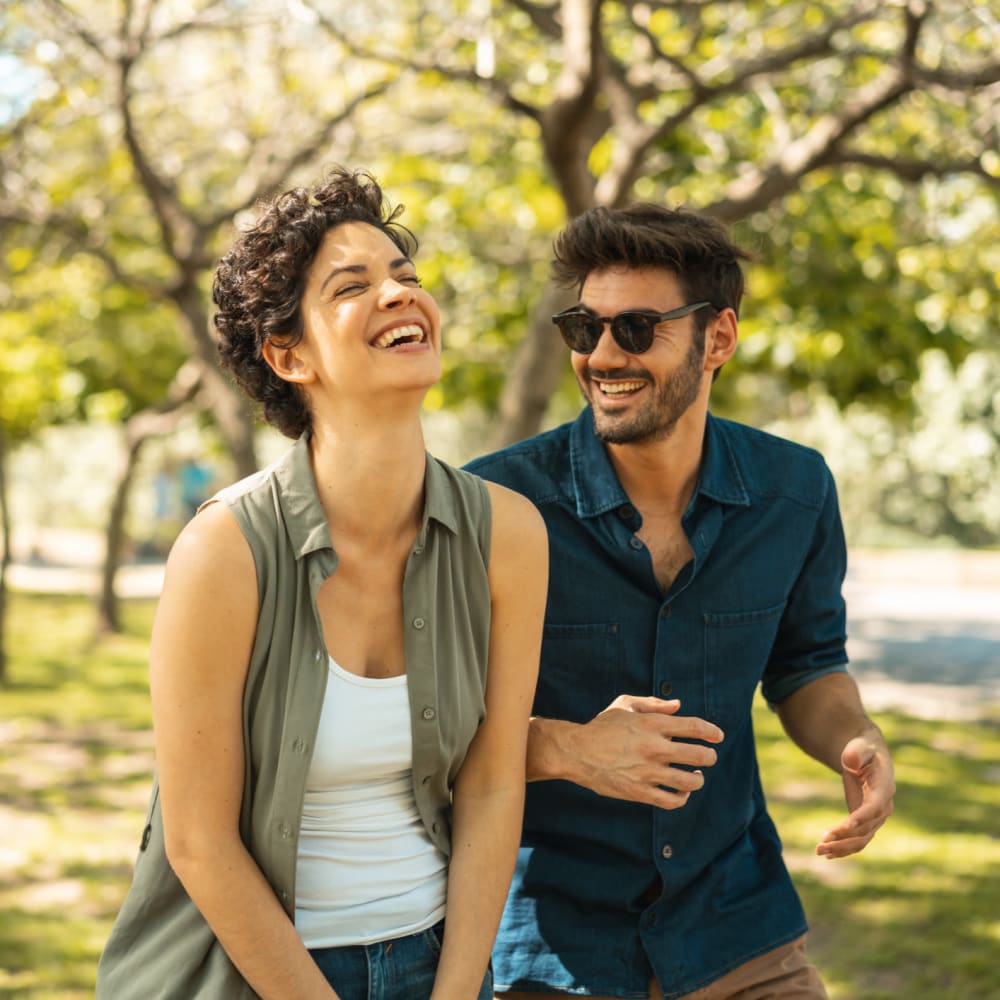 Couple laughing together in a park near 17th Street Lofts in Atlanta, Georgia