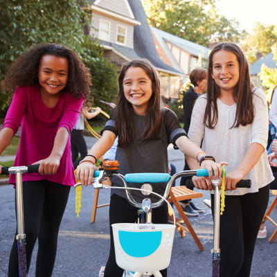Kids riding on scooters and bicycles during a community event at El Centro New Fund Housing (Officers) in El Centro, California