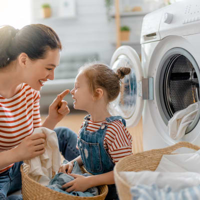 a mother and daughter doing laundry at Greenwood in Joint Base Lewis-McChord, Washington