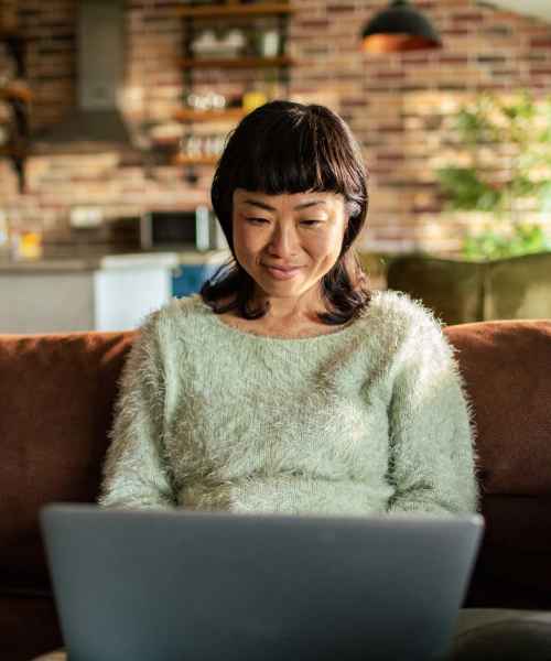 Resident woman using laptop at Forest Ridge in Richmond, Virginia