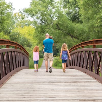 A family walking in a local park near Eagleview in Joint Base Lewis McChord, Washington