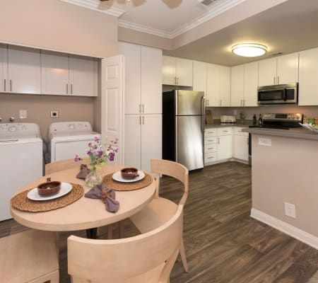 Dining room with a washer and dryer at Paloma Summit Condominium Rentals in Foothill Ranch, California