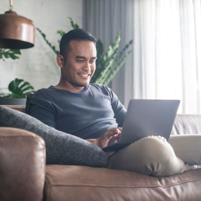 Resident working from home in his cozy living room at Haven Apartment Homes in Kent, Washington