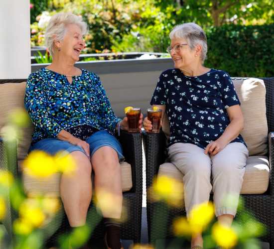 Resident friends poses for a picture at Merrill Gardens at Burien in Burien, Washington. 