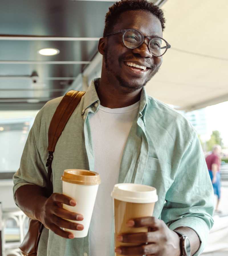 Resident holding coffees at Palm Bay Club in Palm Bay, Florida