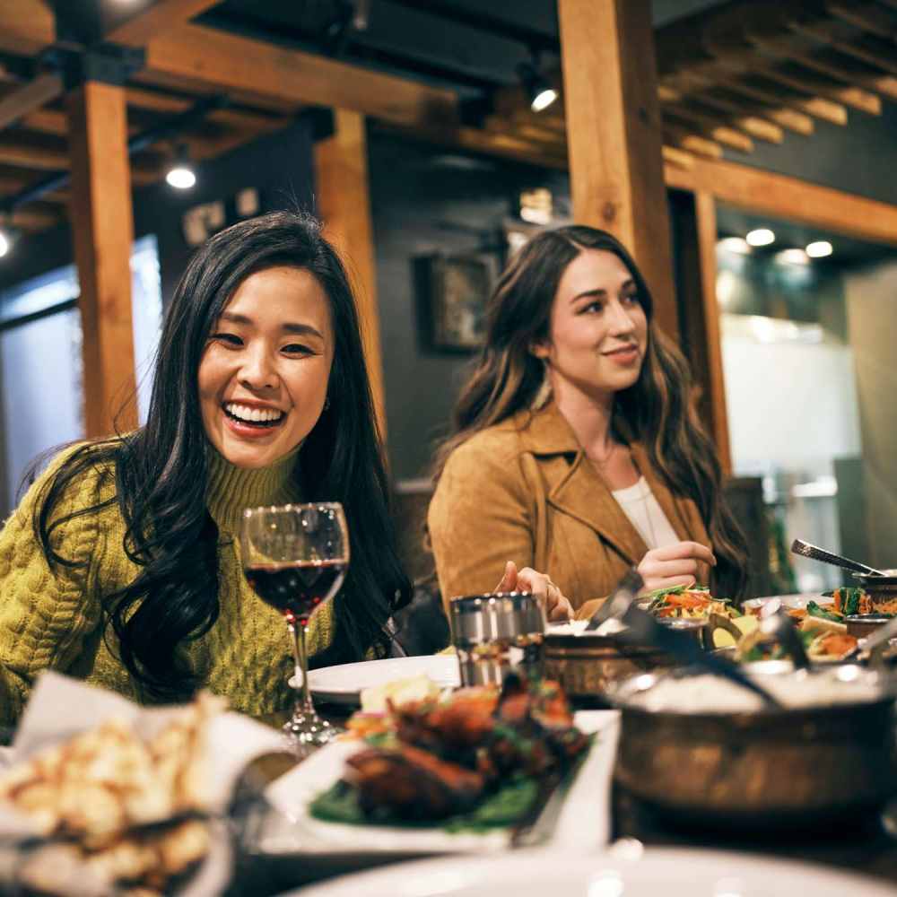 Friends having food in local restaurant near Telegraph Arts in Oakland, California