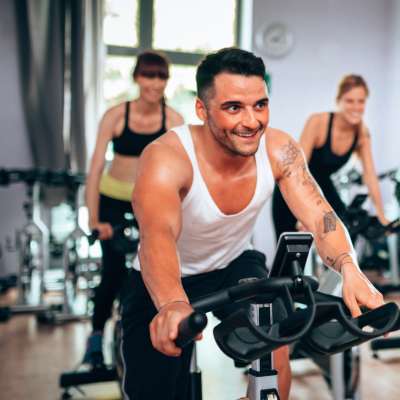 Residents cycling in the community fitness center at The Canopy Apartment Villas in Orlando, Florida