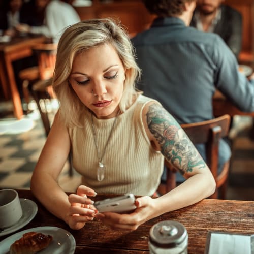 A resident using a mobile phone in a restaurant near Madigan in Joint Base Lewis McChord, Washington