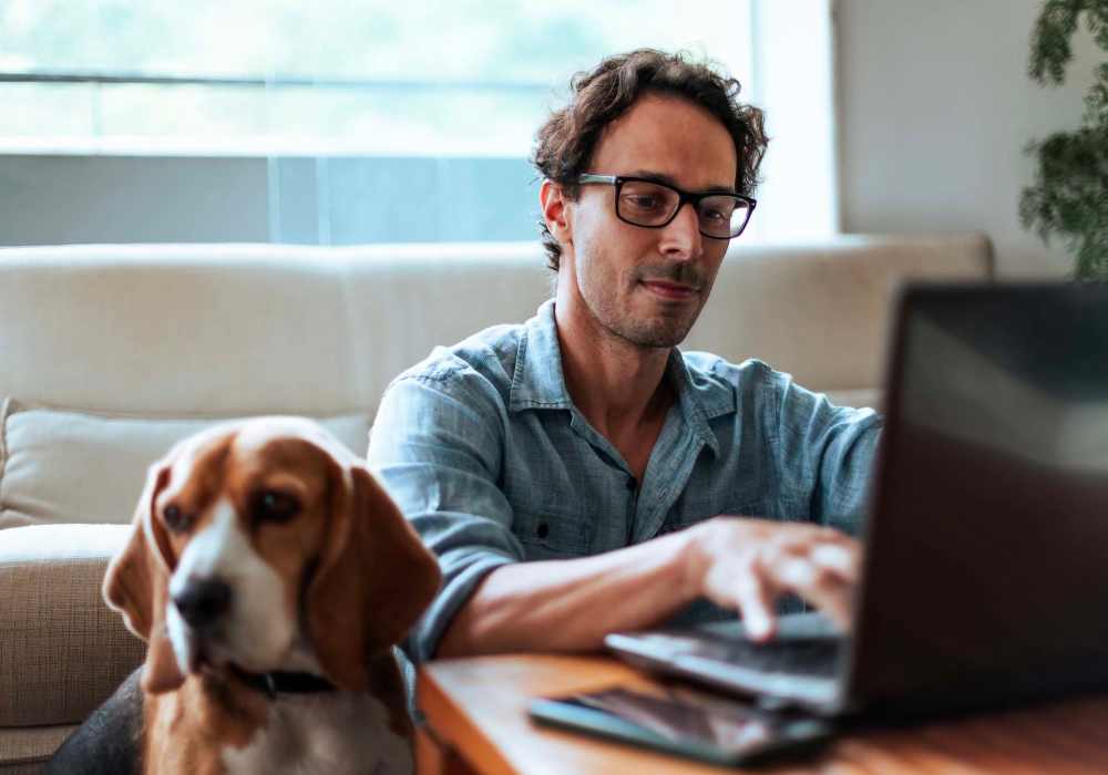 A man working in his laptop at Silo Creek Apartments in Lafayette, Louisiana